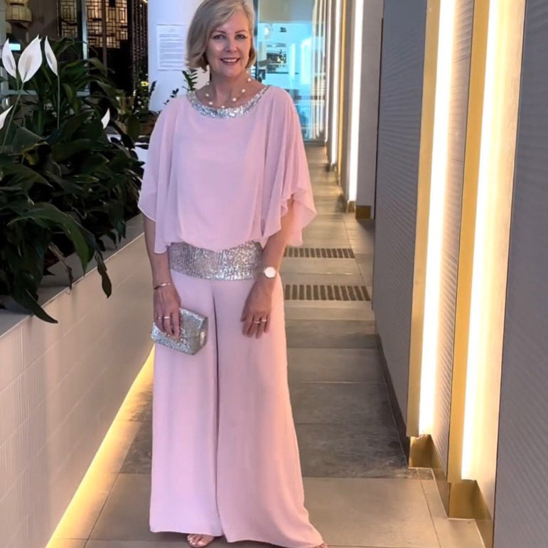 Woman wearing pink wide-sleeve top and wide-leg pants set with sequin trim