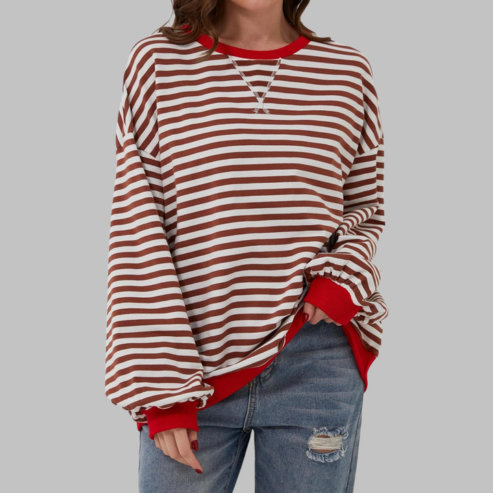 Woman wearing brown and white striped sweatshirt with red contrast trim