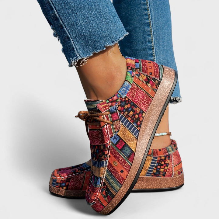 Side-back view of red multicolor patchwork sneakers showing platform sole