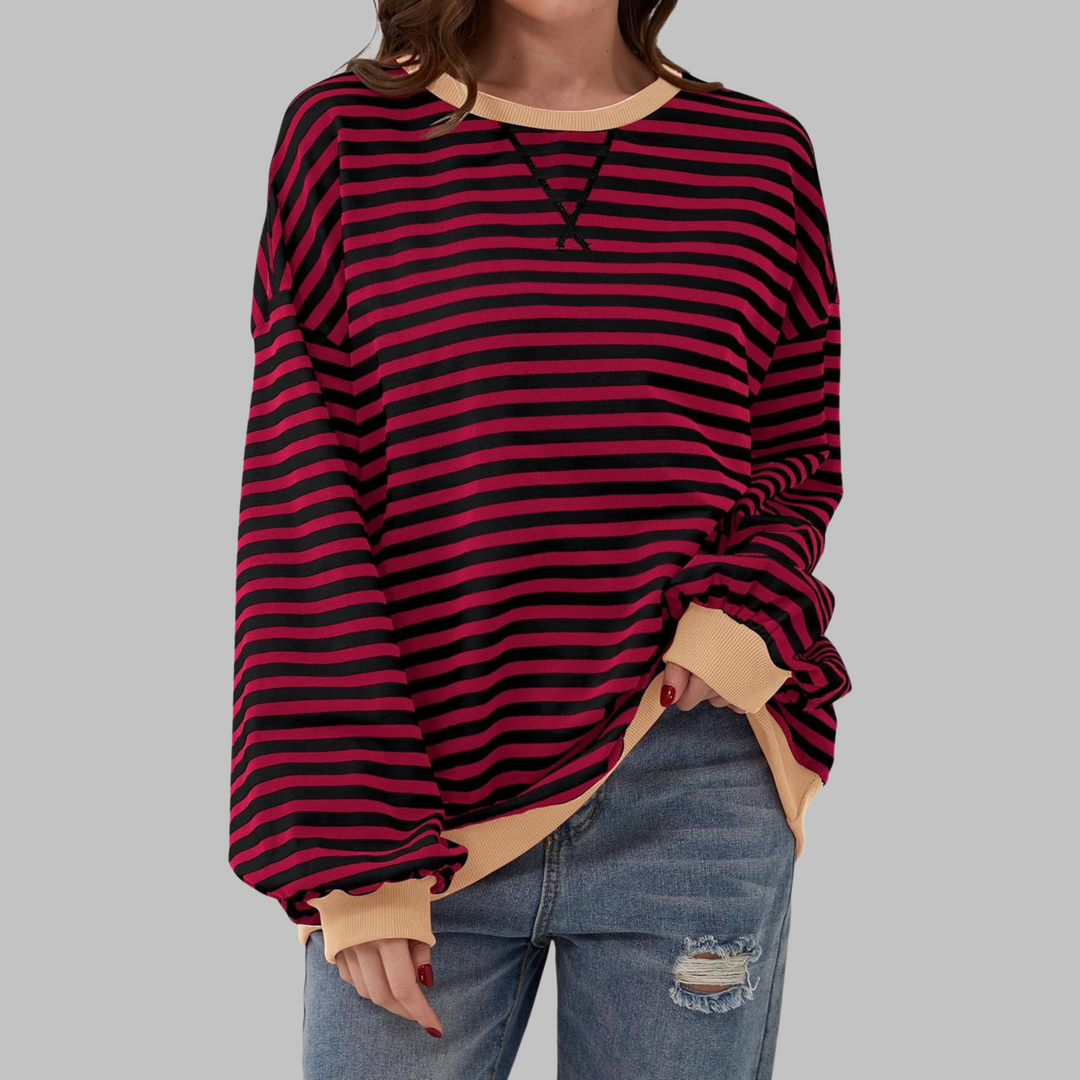 Woman wearing claret and black striped sweatshirt with tan contrast trim