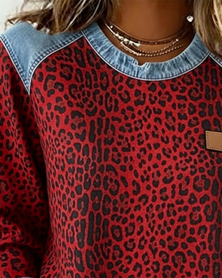 Close up of red leopard print sweatshirt crew neckline and denim yoke