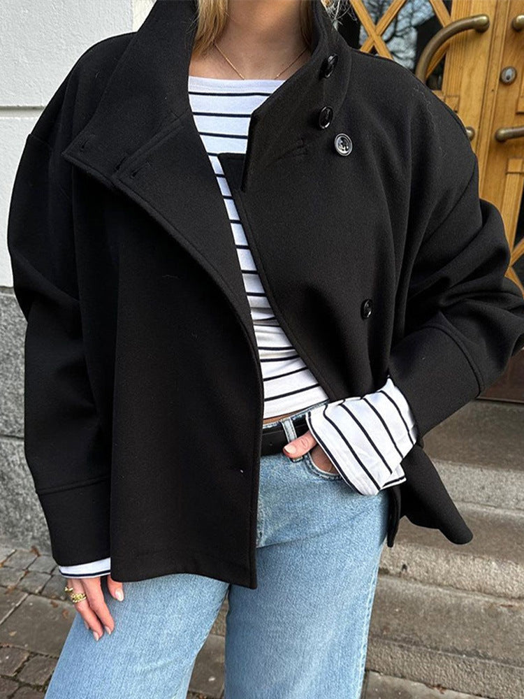 Close up of black funnel neck jacket with asymmetric button front