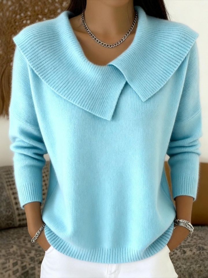 Woman wearing light blue sweater with folded ribbed collar