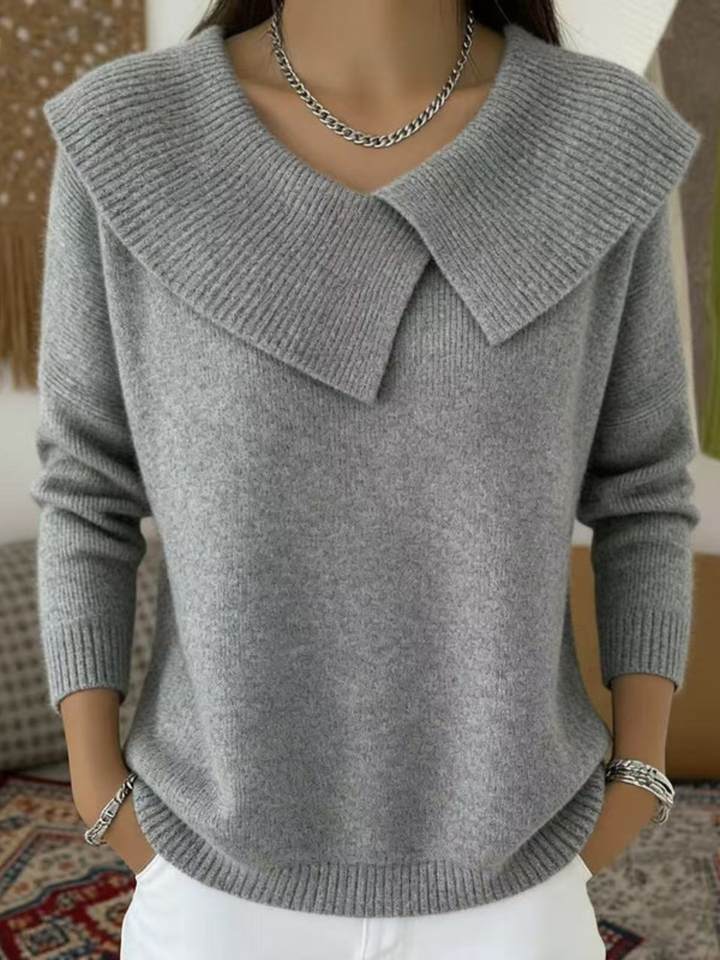 Woman wearing gray sweater with folded ribbed collar