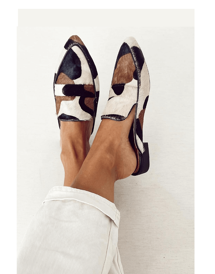 Patchwork printed pointed toe loafers with penny strap and low heel, worn on feet