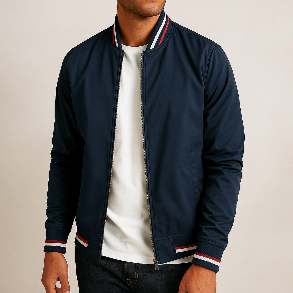 Man wearing navy bomber jacket with striped ribbed collar and cuffs, unzipped over white tee