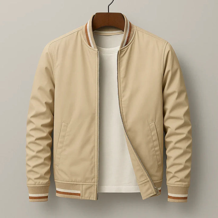 Beige bomber jacket with striped ribbed trim on hanger