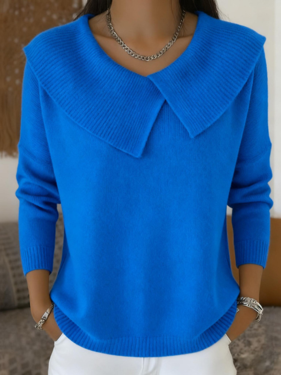 Woman wearing blue sweater with folded ribbed collar
