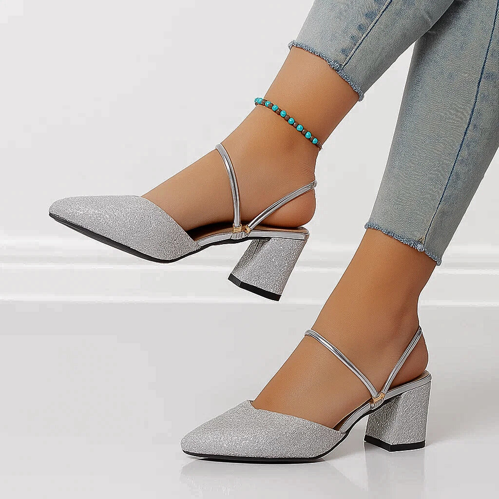 Silver shimmer block heel pumps shown from side with crisscross ankle strap