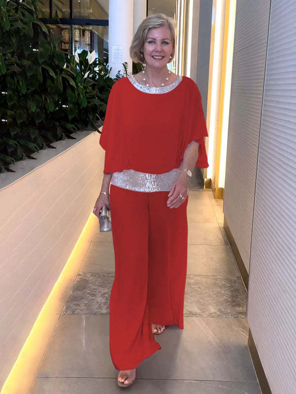 Woman wearing red wide-sleeve top and wide-leg pants set with sequin trim