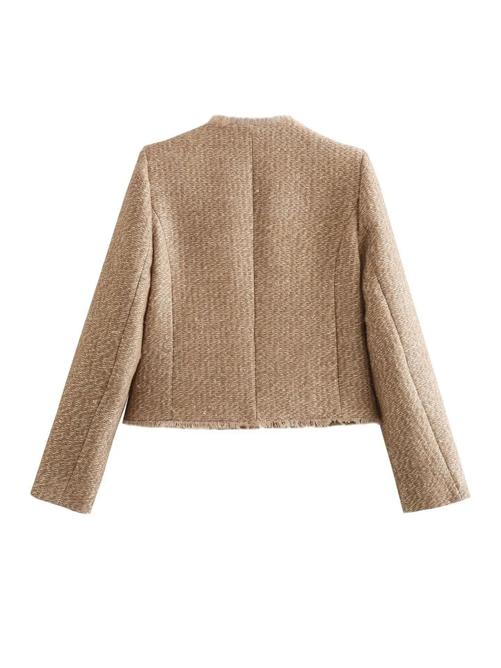 Back view of cropped tweed jacket showing raw frayed hem
