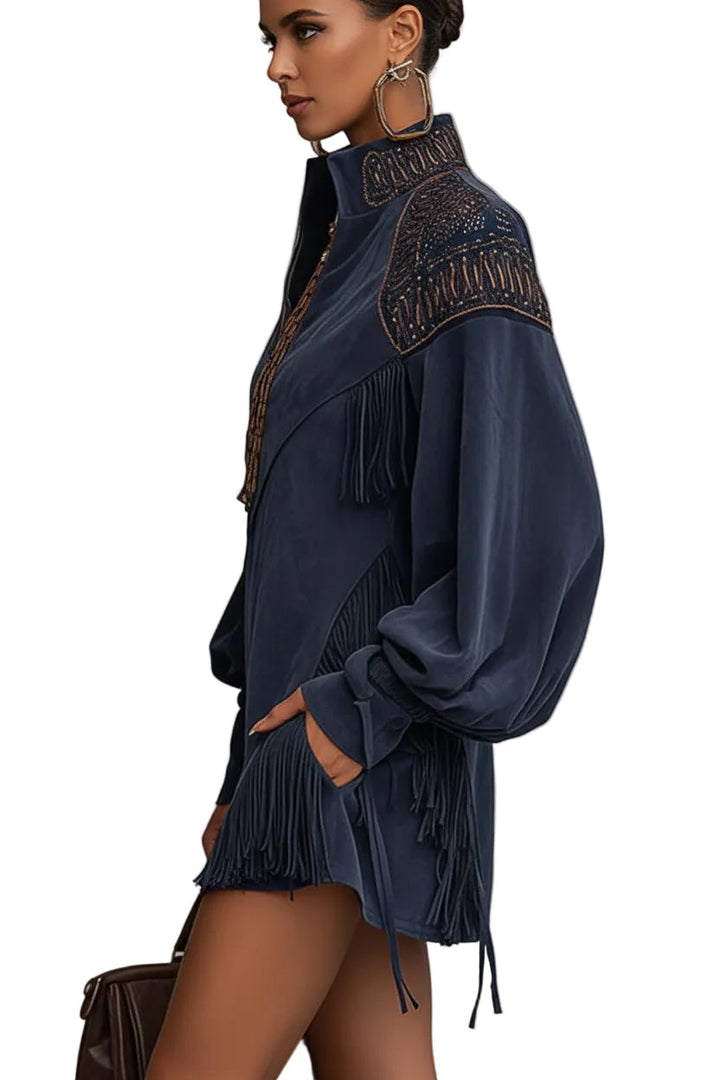 Side profile of indigo faux suede mini dress with embroidered shoulder detail and tassel fringe