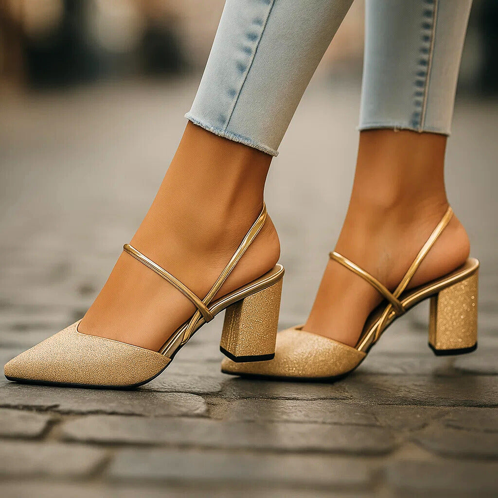 Gold shimmer slingback block heels with crisscross straps, side view on model