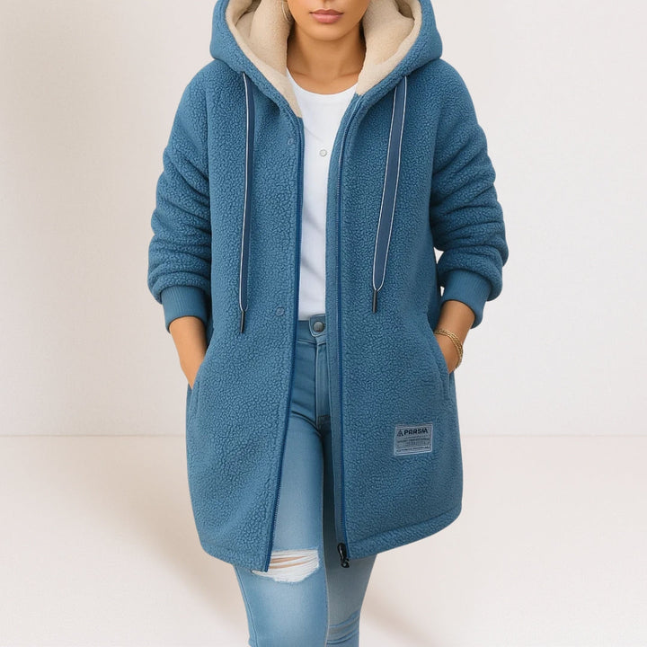 Woman wearing blue sherpa fleece longline hooded jacket with zip front