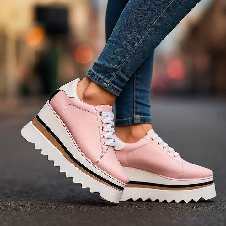 Pink platform lace-up sneakers with white heel panel and tan sole stripe