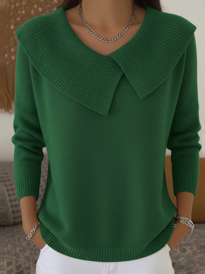 Woman wearing green sweater with folded ribbed collar