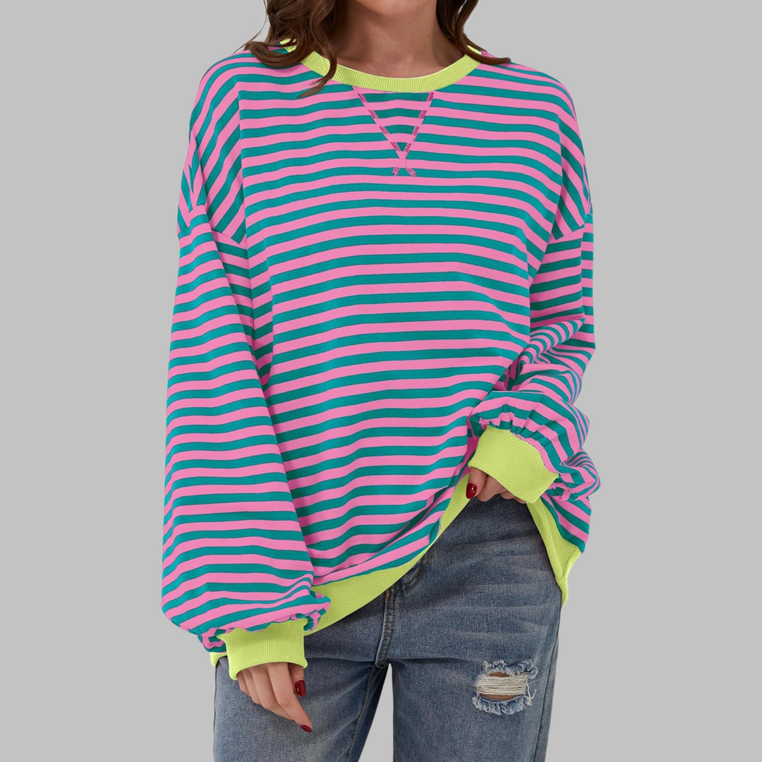 Woman wearing pink and teal striped sweatshirt with neon yellow trim