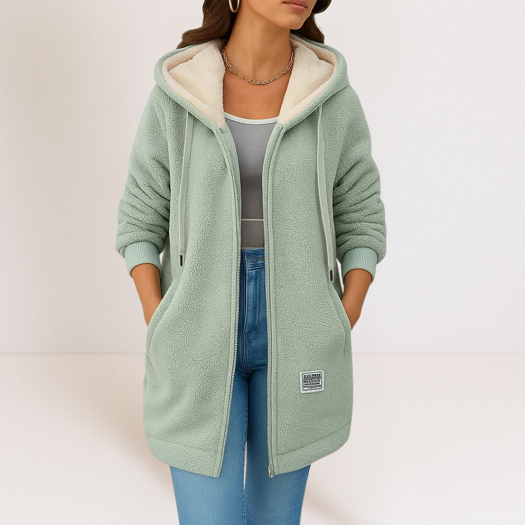 Woman wearing green sherpa fleece longline hooded jacket with zip front