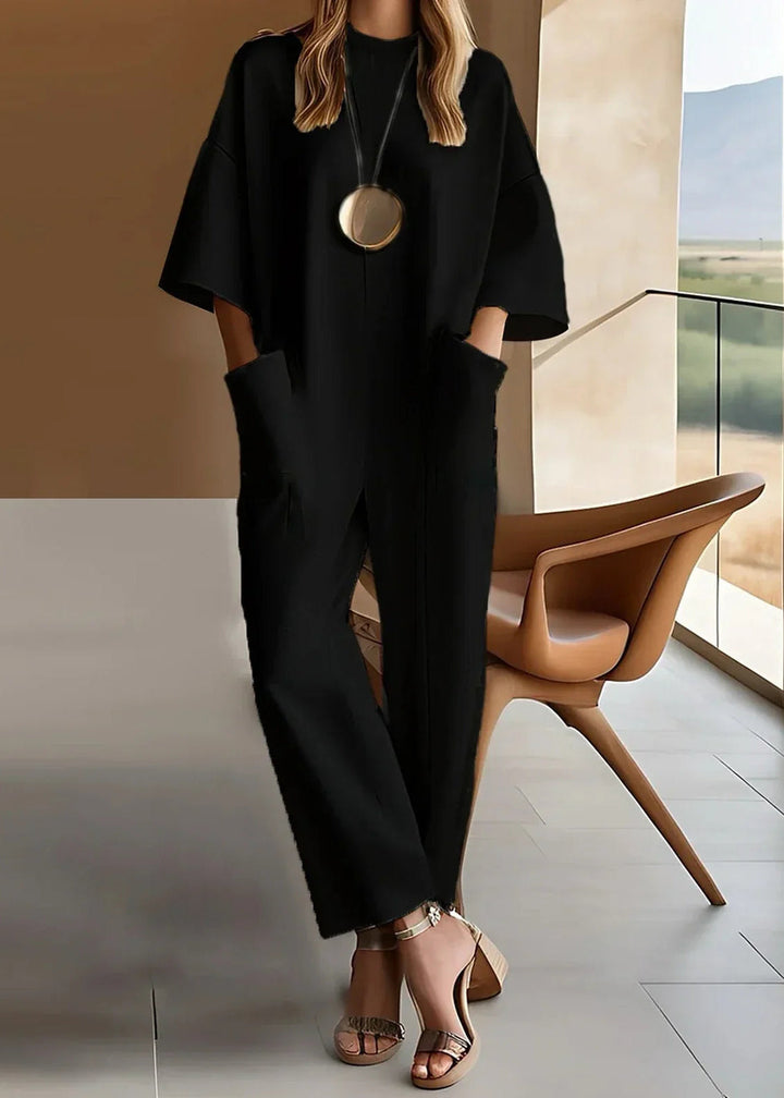 Black wide sleeve jumpsuit with side pockets, full length front view