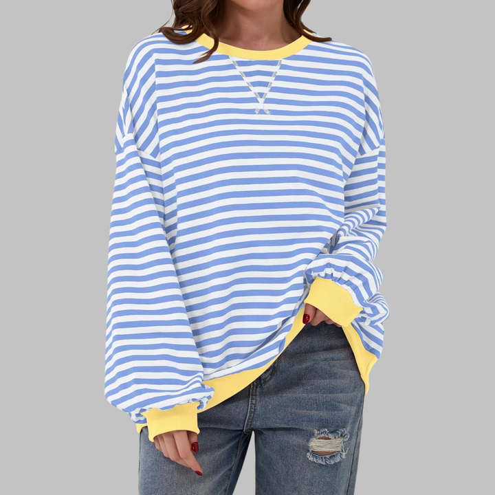 Woman wearing sky blue and white striped sweatshirt with yellow trim