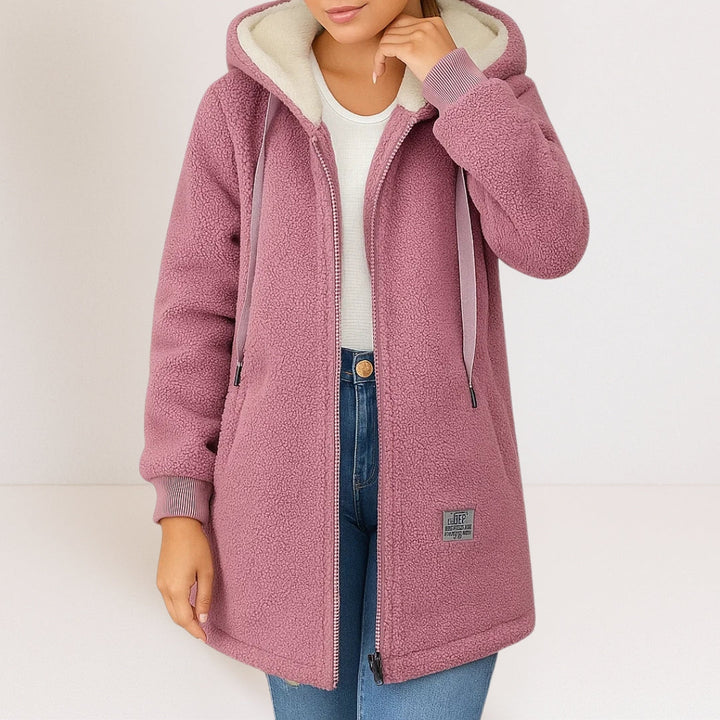 Woman wearing pink sherpa fleece longline hooded jacket with zip front