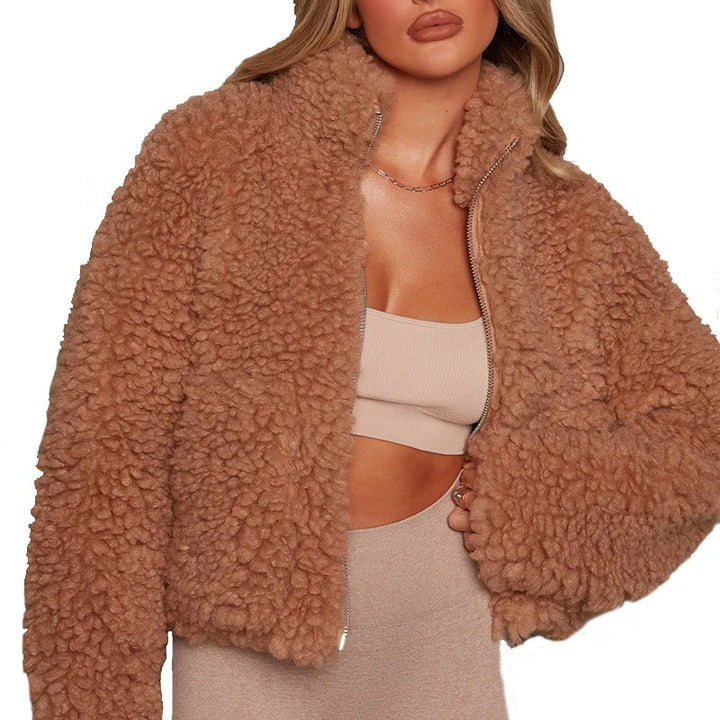 Woman wearing brown curly textured cropped coat with zip front, close up