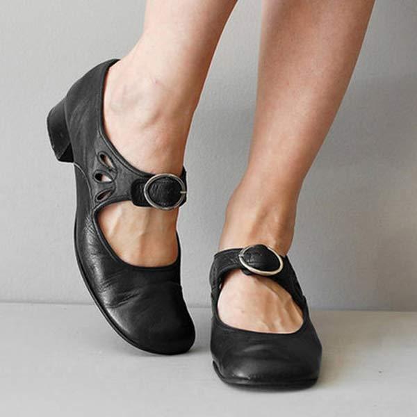 Black leather Mary Jane flats with buckle strap, front view on model