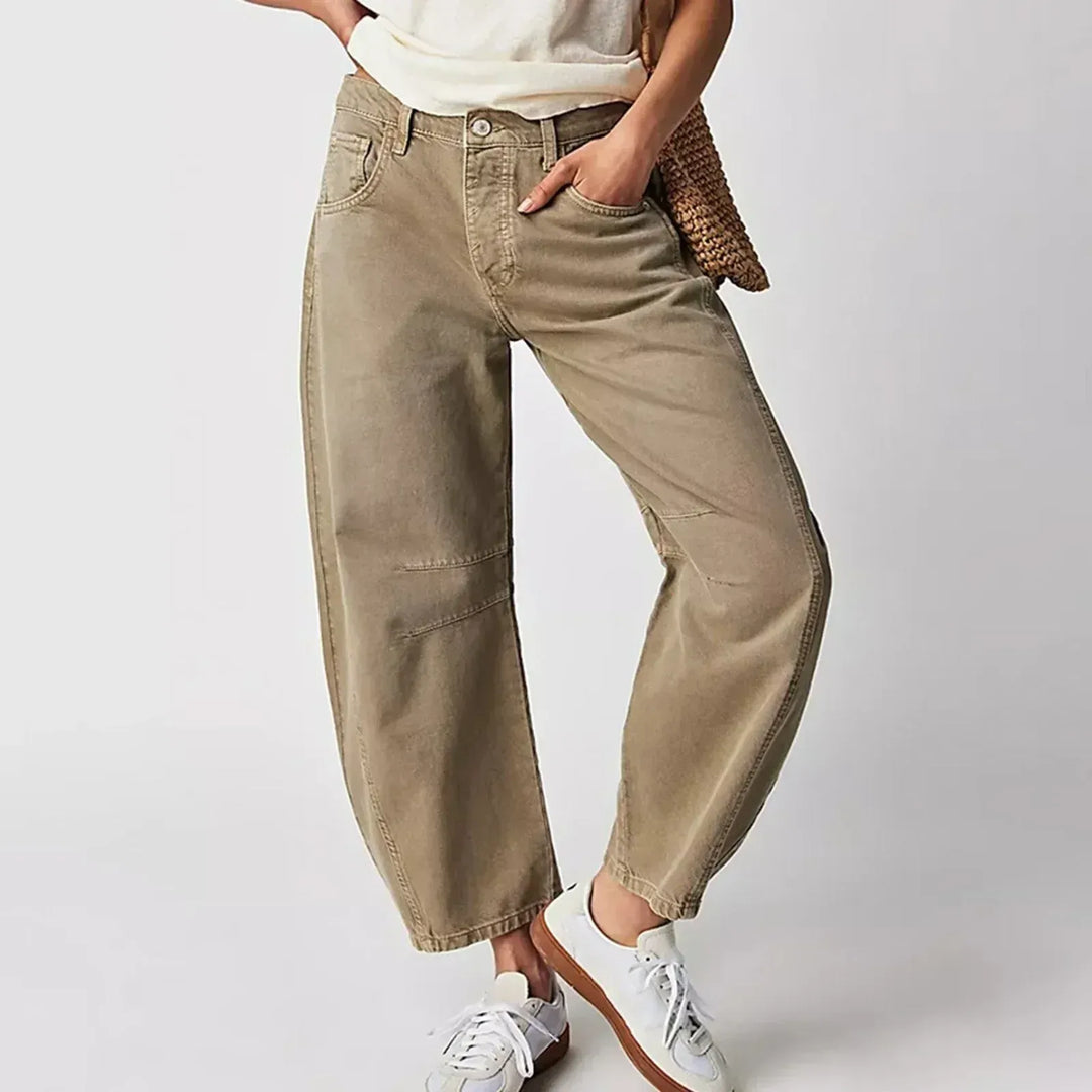 Close up of khaki barrel leg jeans with sneakers