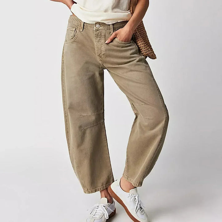 Close up of khaki barrel leg jeans with sneakers