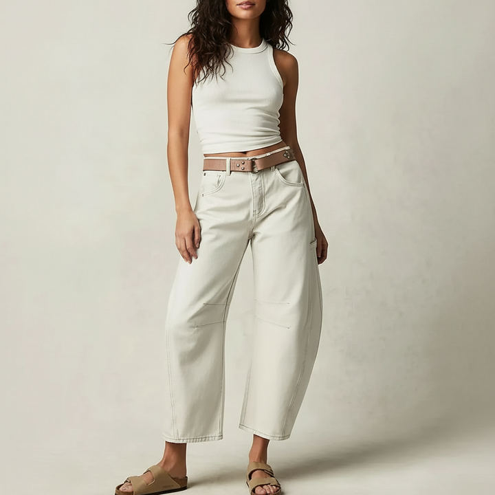 Model wearing off white barrel leg jeans with belt