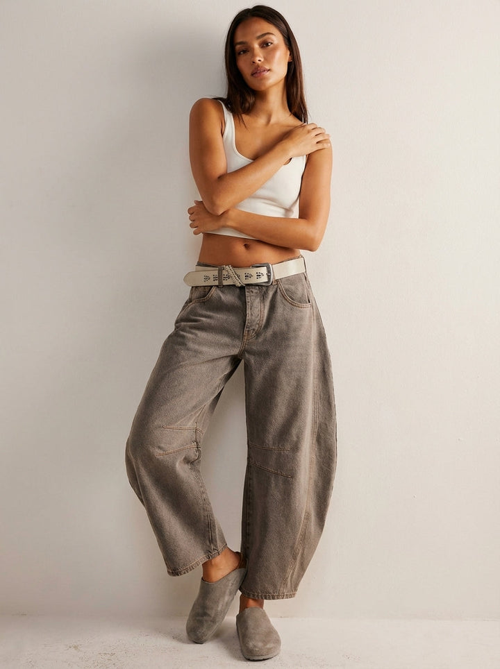 Model wearing brown barrel leg jeans with belt