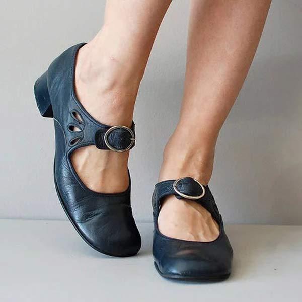Navy blue leather Mary Jane flats, angled front view on model