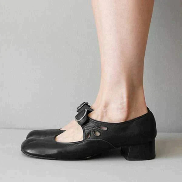 Black leather Mary Jane flat side view showing buckle and cutout