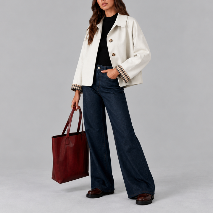Woman wearing white cropped trench jacket with plaid cuffs, front view