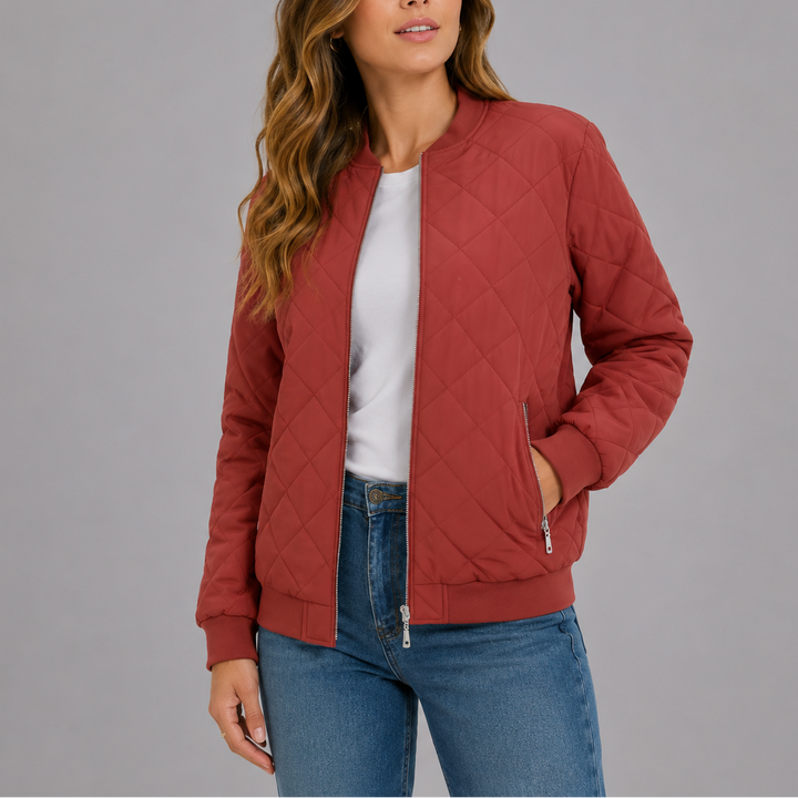 Woman wearing red diamond quilted bomber jacket with zip front