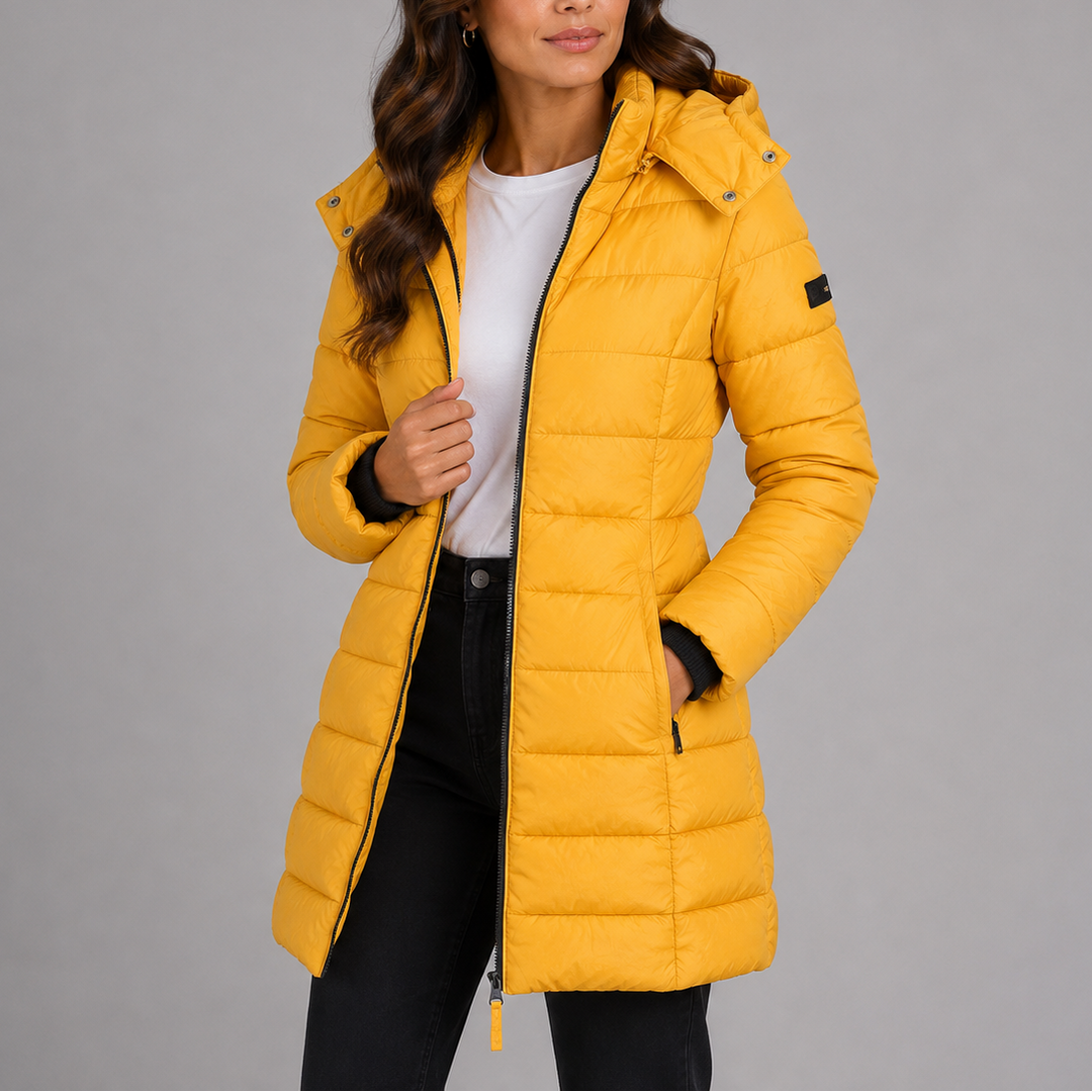 Woman wearing yellow hooded puffer jacket, front view