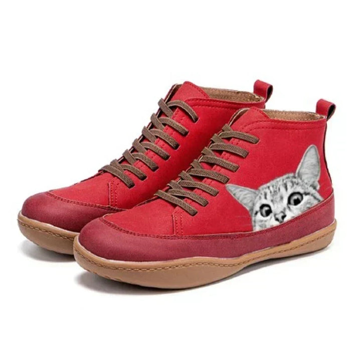 Red high top boots with cat print detail, side view