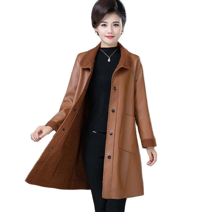 Smiling woman modeling khaki faux leather longline jacket with shearling collar