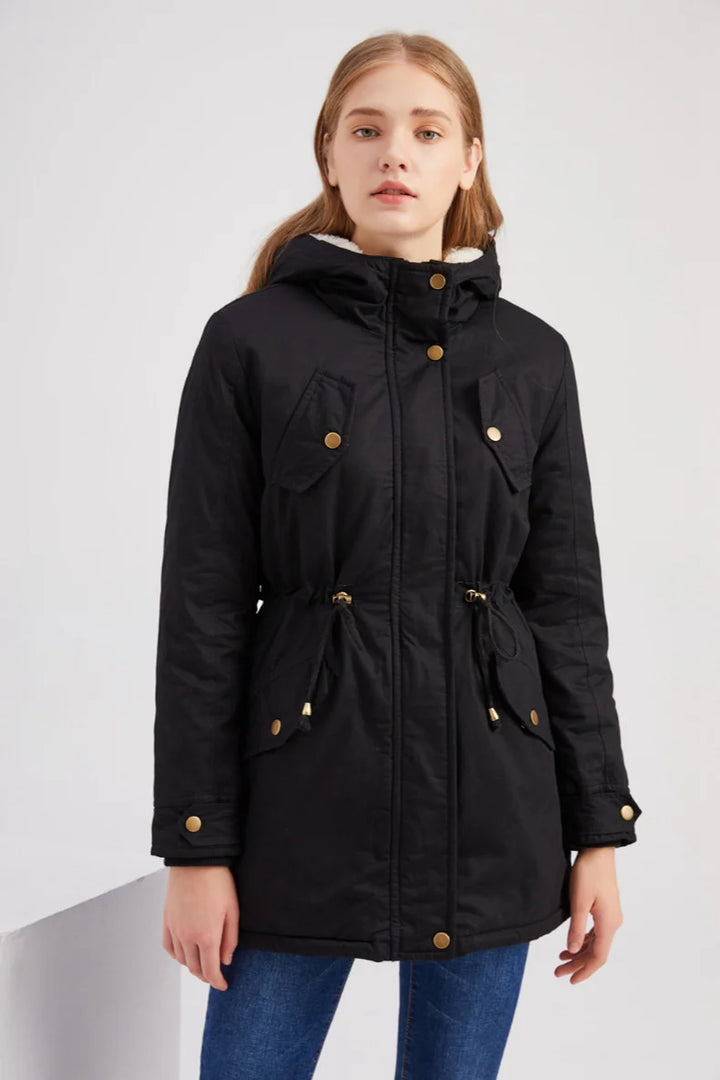 Model wearing black hooded parka coat, front view