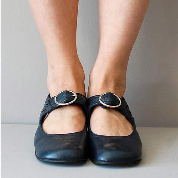 Navy blue leather Mary Jane flats with buckle strap, front view on model