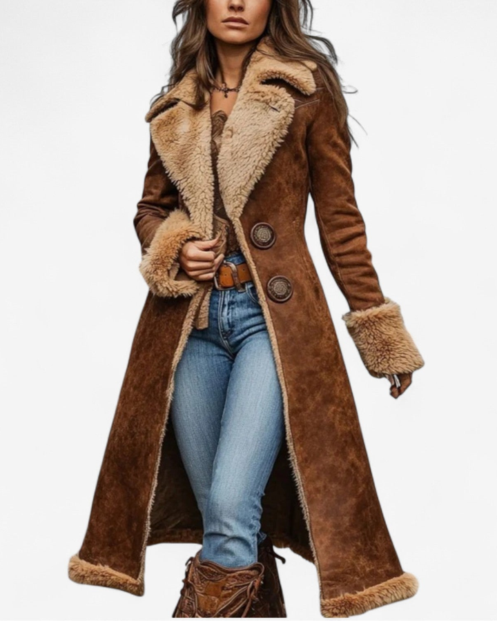 Woman wearing long brown faux suede coat with shearling collar and cuffs, front view