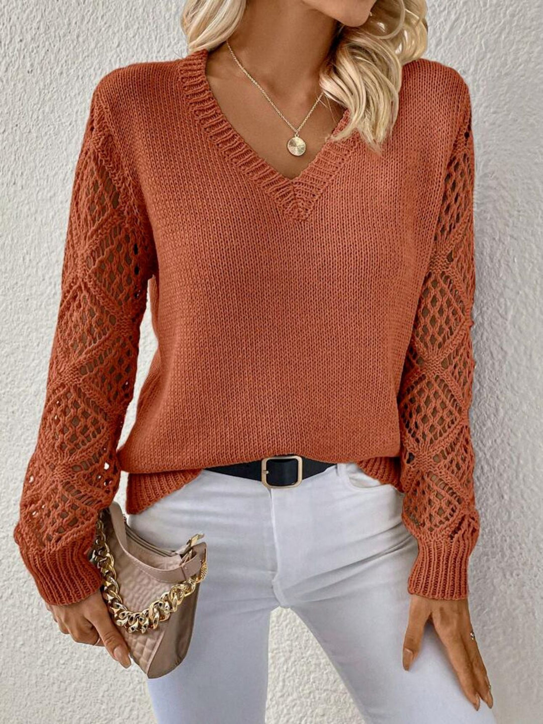Rust orange open knit sweater with crochet sleeves, front view