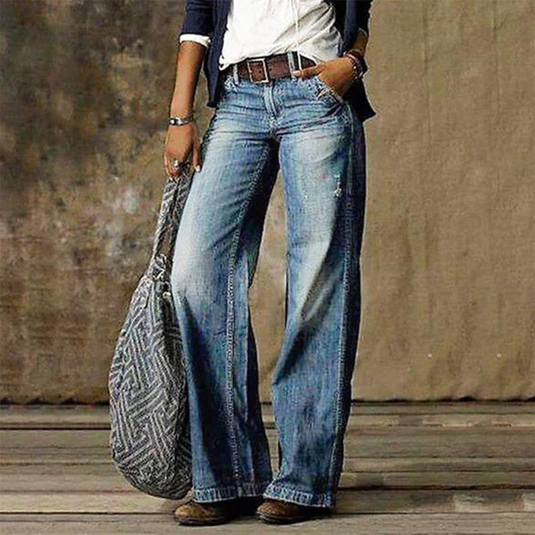 Woman wearing light blue wide leg vintage wash jeans with belt