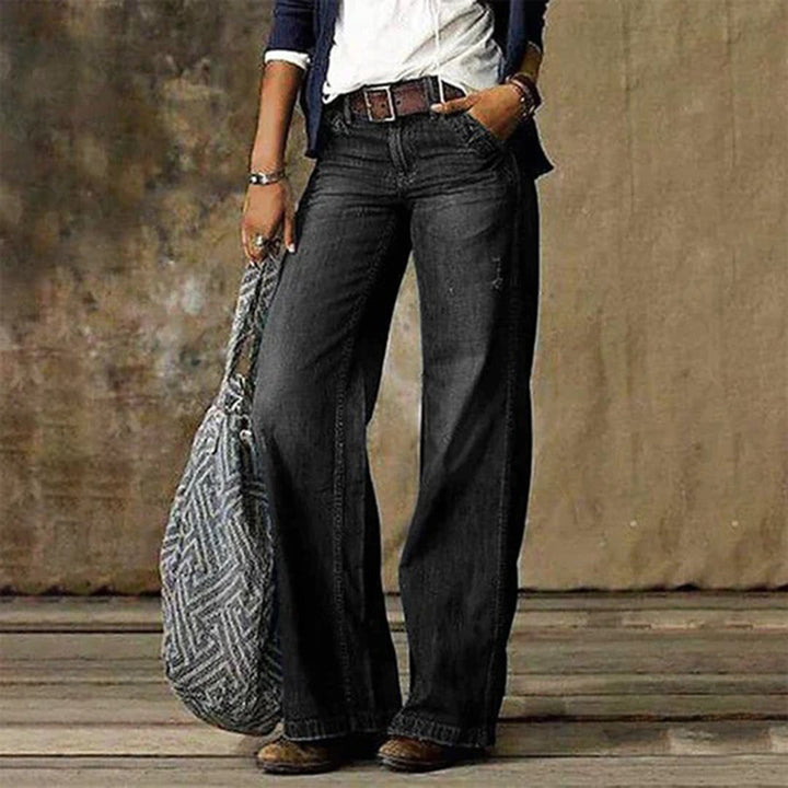 Woman wearing black wide leg vintage wash jeans with belt