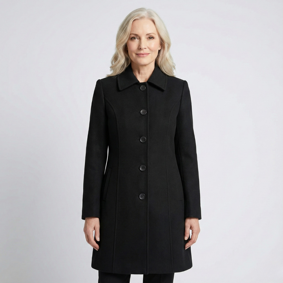 Woman wearing black fit and flare coat with point collar and buttons