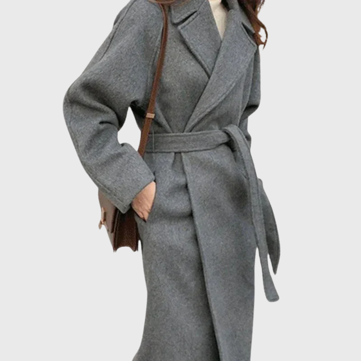 Model wearing grey belted wool blend coat, side view