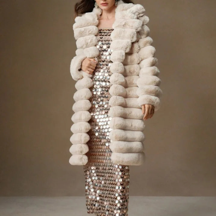 Woman wearing light brown faux fur mid-length coat over sequin dress