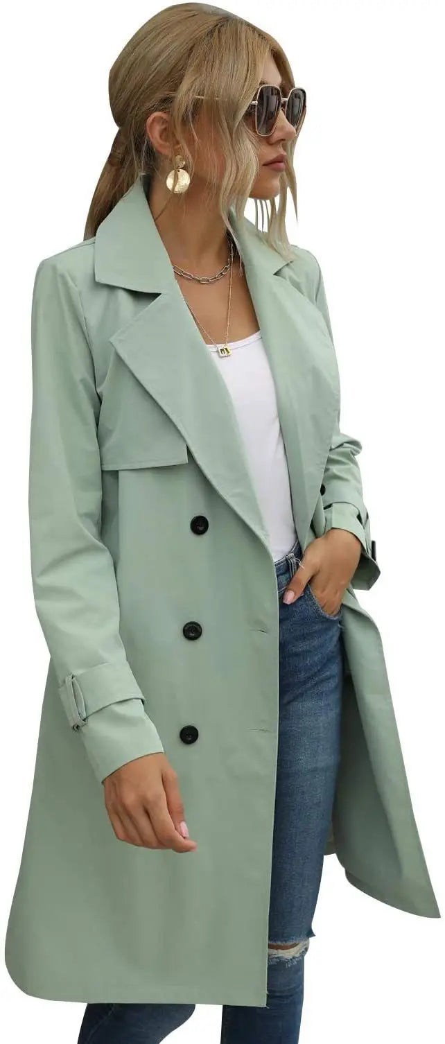 Woman wearing sage green trench coat, side angle