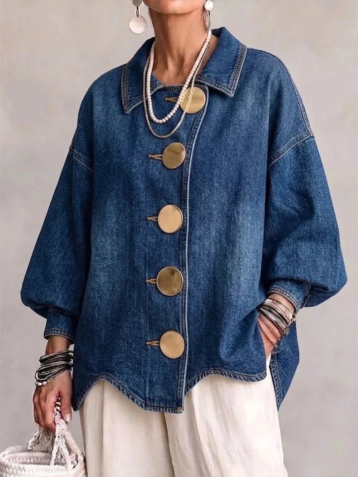 Woman wearing blue denim jacket with large gold buttons, front view