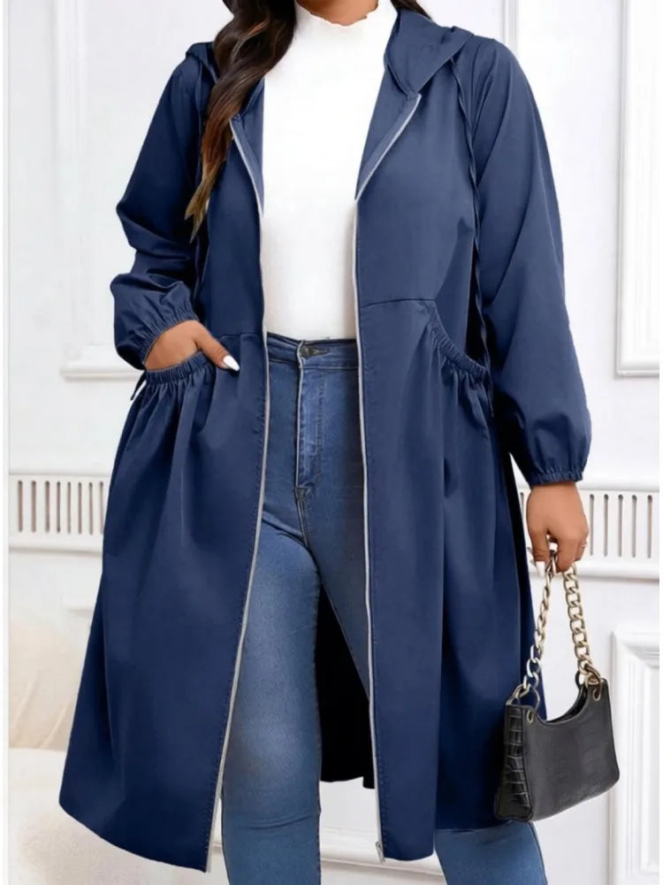 Woman wearing navy hooded long coat with gathered waist